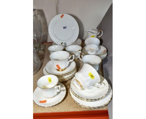 A ROYAL ALBERT 'VAL D'OR' TEA SET, comprising six tea cups and six saucers, a coffee cup and saucer, seven tea plates, six de