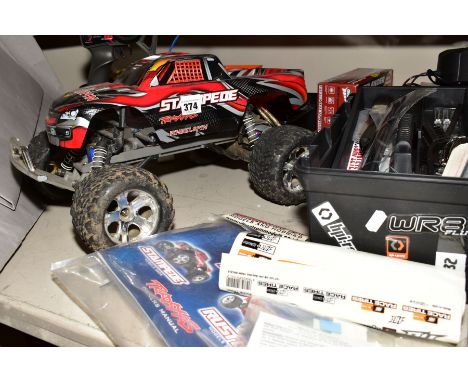 A REMOTE CONTROL TRAXXAS STAMPEDE WHEELSPIN TRUCK AND A QUANTITY OF ACCESSORIES, SPARE PARTS AND TOOLS, with owner's manual f