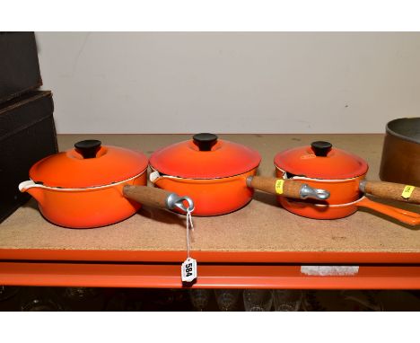 THREE LE CREUSET ORANGE ENAMEL SAUCEPANS AND LIDS, two 20cm and one 16cm and a Le Creuset frying pan 16cm, all in well used c