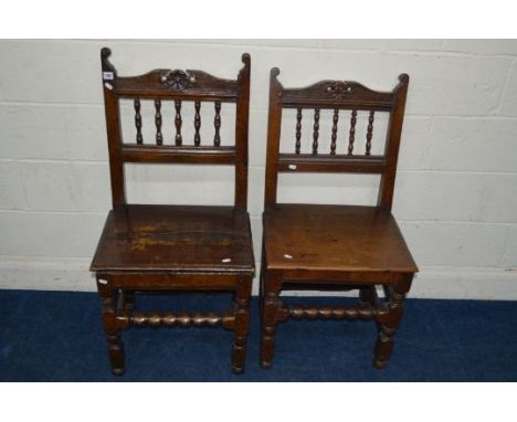 A NEAR PAIR OF EARLY 19TH CENTURY HEAVY OAK HALL CHAIRS, carved and spindled back, on turned and block legs united by bobbin 