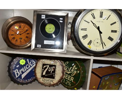 A GROUP OF REPRODUCTION ADVERTISING SIGNS AND CLOCKS, to include three wall hangings in the shape of large bottle tops, Bruck