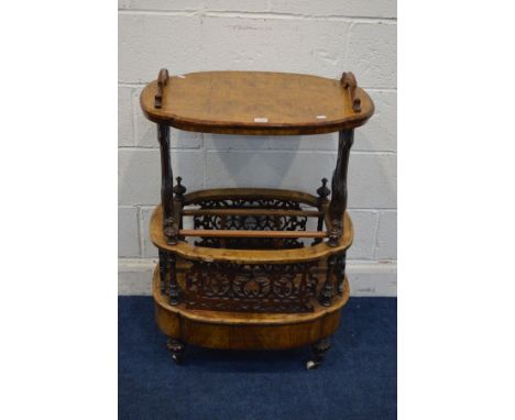 A LATE VICTORIAN BURR WALNUT CANTERBURY, shaped oval top with handles, on foliate scrolling end supports, with three division
