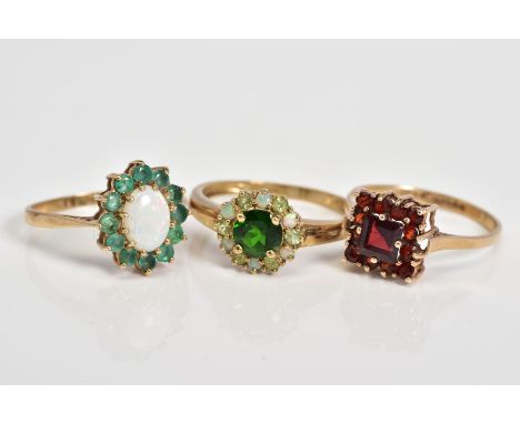 THREE 9CT GOLD GEM SET CLUSTER RINGS, to include an oval cut opal with a circular cut emerald surround, with a 9ct hallmark f