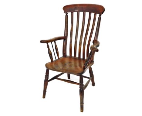 A Victorian beech and elm lath back kitchen chair, with solid saddle seat, stamped to the back with initials, raised on ring 