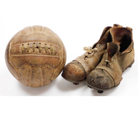 A pair of vintage leather football boots, marked as size 8, together with a stitched leather football.