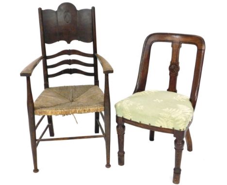 A late 19thC Arts &amp; Crafts type oak ladder back chair, with rush seat, together with a Victorian oak salon chair. (2)