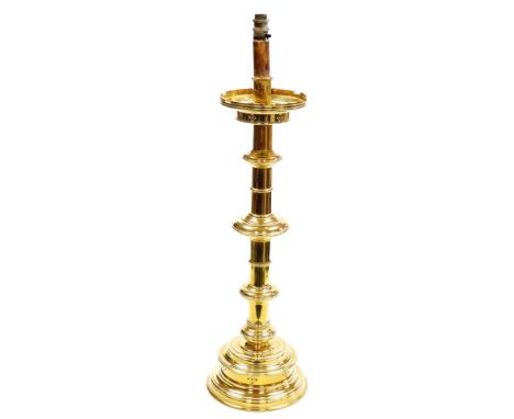 A Victorian brass altar candlestick, converted to electricity, 79ccm high.