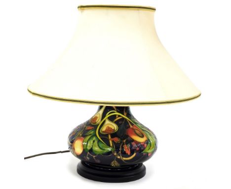 A Moorcroft pottery Queen's Choice table lamp, of compressed out swept form, with shade, 46cm high including shade. 