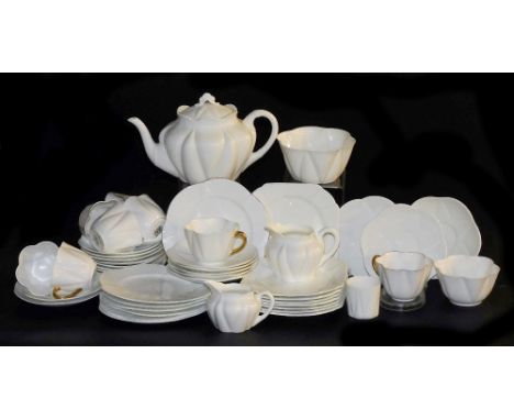 An early 20thC Shelley white glazed part tea service, Dainty shape, with gilt rims and handles, comprising teapot, pair of gr