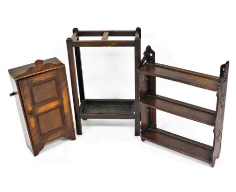 A Victorian Gothic oak wall shelf, of three shelves, 60cm high, 47cm wide, together with an oak two tier stick stand, 55cm hi