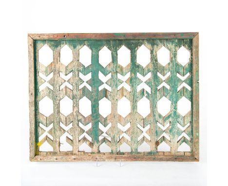 Decorative geometric fretwork designs. Lightly patinated.A hand made and decorated wooden window trellis covering, placed ove