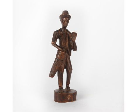 Wooden figure of a barefoot man playing a drum. Issued: 20th c. Dimensions: 11.75""H Provenance: David Farin Collection 