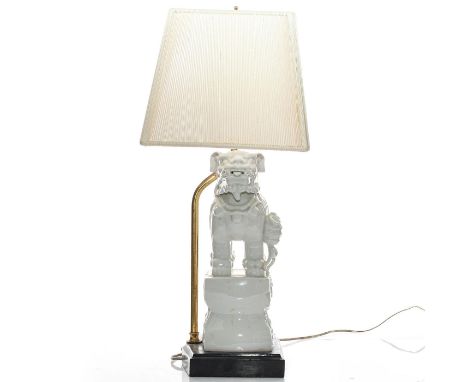 Glazed white lustre with profuse mthical symbols. Cloth shade.A vintage allegorical ceramic lamp modeled as a highly detailed
