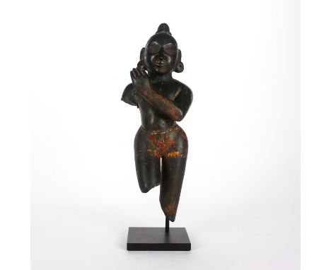 The youthful avatar of Vishnu capering and playing flute.Primitivistic&nbsp;large schist figure of Krishna, a major deity in 