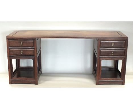 A Chinese rosewood two pedestal desk, mid-20th century, the rectangular single panel top set within a simple frame sitting fl