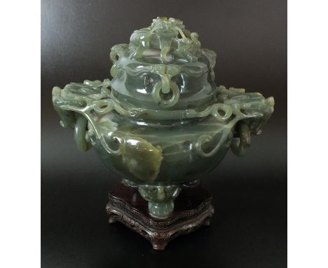 A Chinese jadeite tripod censer and cover, 20th century, of a dense green tone with brown inclusions, raised on three squat c