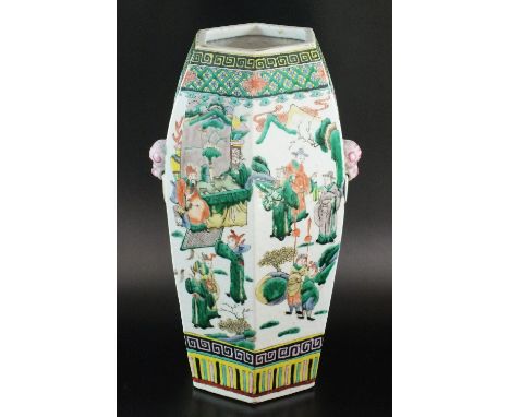 A Chinese porcelain famille verte hexagonal vase, 20th century, of ovoid form with moulded fu dog form handles, painted with 