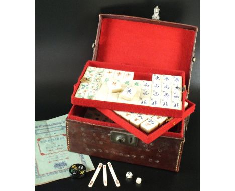 A Chinese bamboo and bone Mahjong set in leather case, first quarter 20th century, the rectangular form case opening to revea