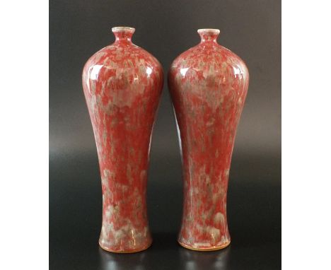 A pair of Chinese sang de boeuf glaze vases, 19th century, each of ovoid form, the oxblood glaze streaked with ash greens, gr