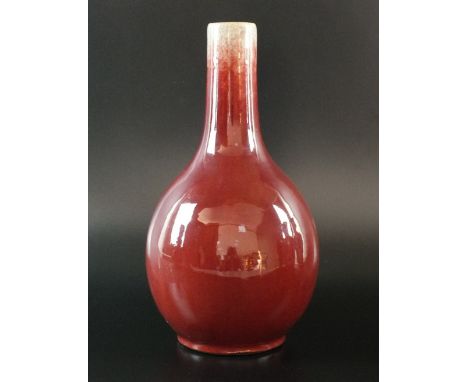 A Chinese flambé bottle vase, first half 19th century, the globular form body covered with all over oxblood crackle glaze thi