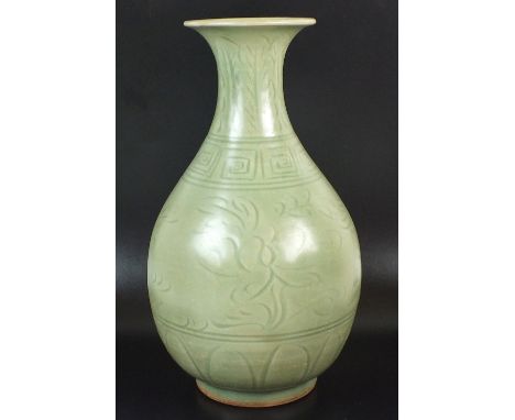 A Chinese dark celadon glaze vase, late 20th century, of pear shape form with flared lip, fluidly decorated with an incised f