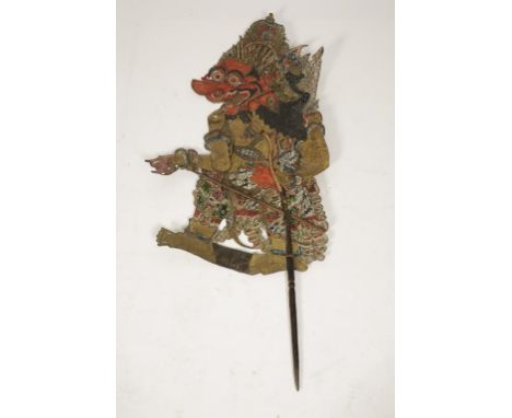 AN INDIAN PUPPET all over painted and pierced on leather with articulated arm, 39". Provenance: The Peter Wood Collection