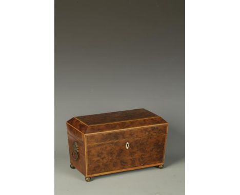 A REGENCY BURR YEW TEA CADDY, the rectangular top with canted sides and satinwood stringing, the interior fitted with twin li