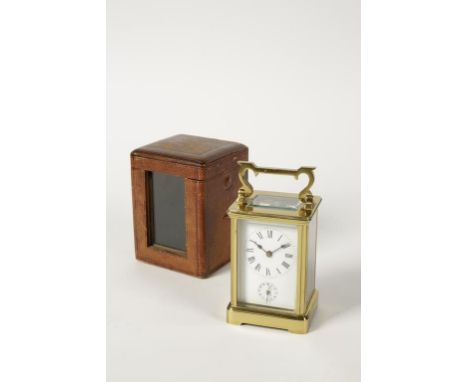 A FRENCH BRASS CASED ALARM CARRIAGE CLOCK, the white enamel dial with Roman numerals and subsidiary alarm dial, in a plain br