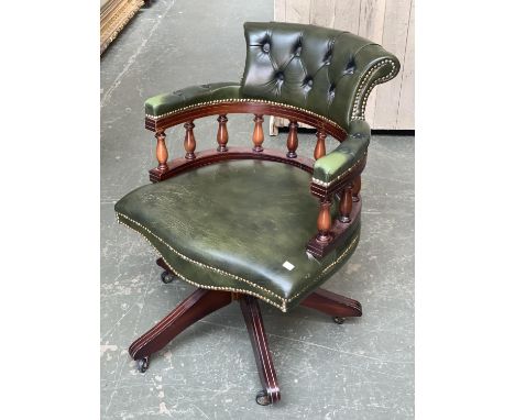 A reproduction green leather and button upholstered swivel captain's chair, 63cmW 