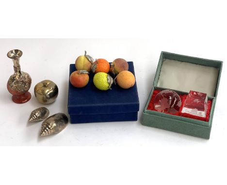 A set of six hand painted ceramic fruits with white metal leaves; two continental white metal conch shells with engraved desi