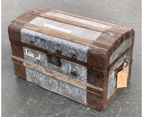 A metal and wood banded domed travel trunk, 67cmW; together with a metal travel case, 58cmW 