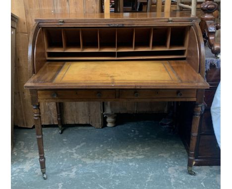 A Regency mahogany cylinder writing desk c.1825, the reeded edge top over the two cylinder fall enclosing a fitted interior w