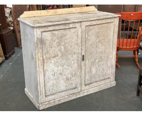 A Victorian painted pine boot room cupboard, with two fielded panel doors, opening to various compartments, on a plinth base,