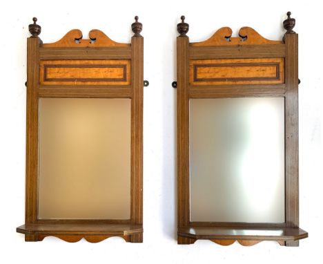 A pair of mahogany and burr maple wall mirrors with bevelled glass and shelf, each 56x29cm 