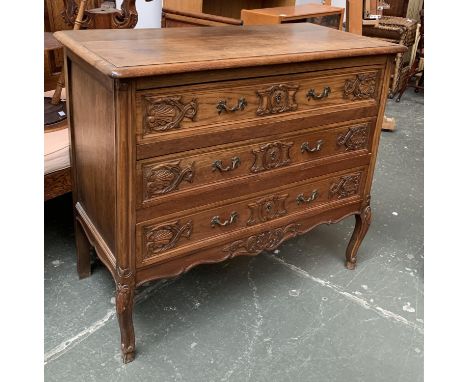 A Continental commode chest of three drawers, carved with shells, on cabriole legs, 101x49x87cm 