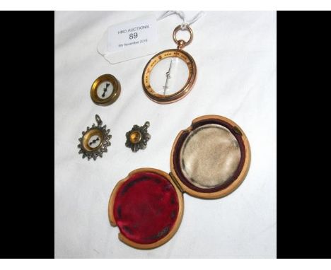 A 9ct gold compass in travelling case, together with three other miniature compasses CONDITION REPORT4cm diameter of gold cas