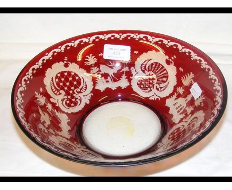 A 25cm diameter red overlay glass bowl with engraved hunting and bird decoration 