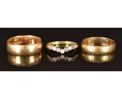 Two 9ct gold wedding bands/ rings (sizes M/N, 2.5g and Q, 3.3g) and a 9ct gold ring set with diamonds and amethysts, size L, 