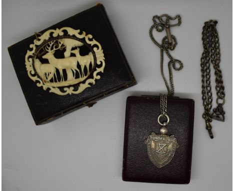 A carved ivory brooch in the form of deer, silver necklace and fob and a silver Albert