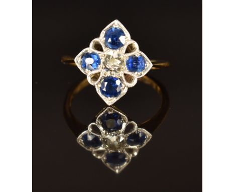 An 18ct gold ring set with a diamond of approximately 0.25ct and cushion cut sapphires, size K, 2.4g&nbsp;