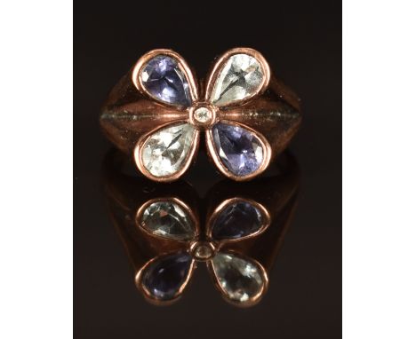 A 9k rose gold ring set with aquamarine, iolite and a white sapphire in a flower setting, size L/M, 4.7g&nbsp;