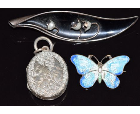 Victorian silver locket, an enamel set silver butterfly and a Norwegian silver brooch set with enamel&nbsp;