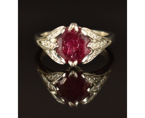 A platinum ring set with a round cut ruby and with diamonds to the shoulders, size K/L, 6.9g&nbsp;