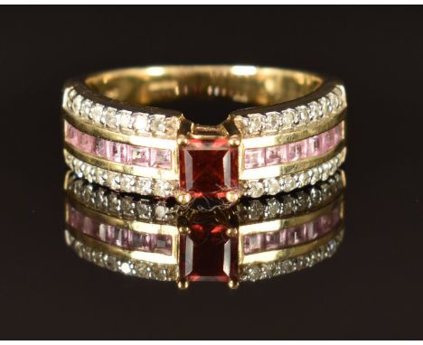 A 9k gold ring set with a garnet, pink sapphires and diamonds, size M, 4.2g