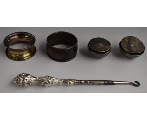 Two hallmarked silver napkin rings, pair of white metal heavy horse harness or similar adornments and a hallmarked silver han