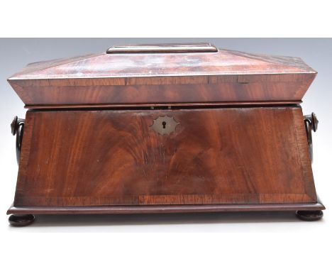 Late Regency William IV flame mahogany and&nbsp;rosewood sarcophagus tea caddy with ring handles and bun feet. The interior w