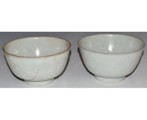 Two Chinese Kangxi period pedestal bowls with ivory glaze, from the Vung Tau cargo, with original Christie's labels