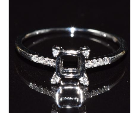 An 18ct gold ring mount set with diamonds to the shoulders and setting, size M