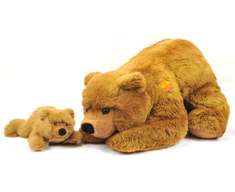 Steiff pair of plush brown teddy bears, both are unjointed and recumbent: (1) Urs bear, yellow tag 069680, unjointed, with ca