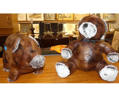 Two contemporary stitched soft tan leather door-stops, one modelled as a teddy-bear and the other as a pig, with original lab